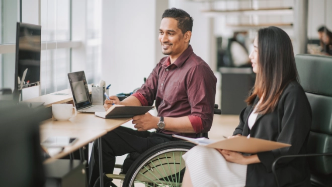 disabled man having a meeting with a woman colleague