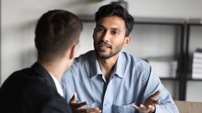 man talking with another man using hands