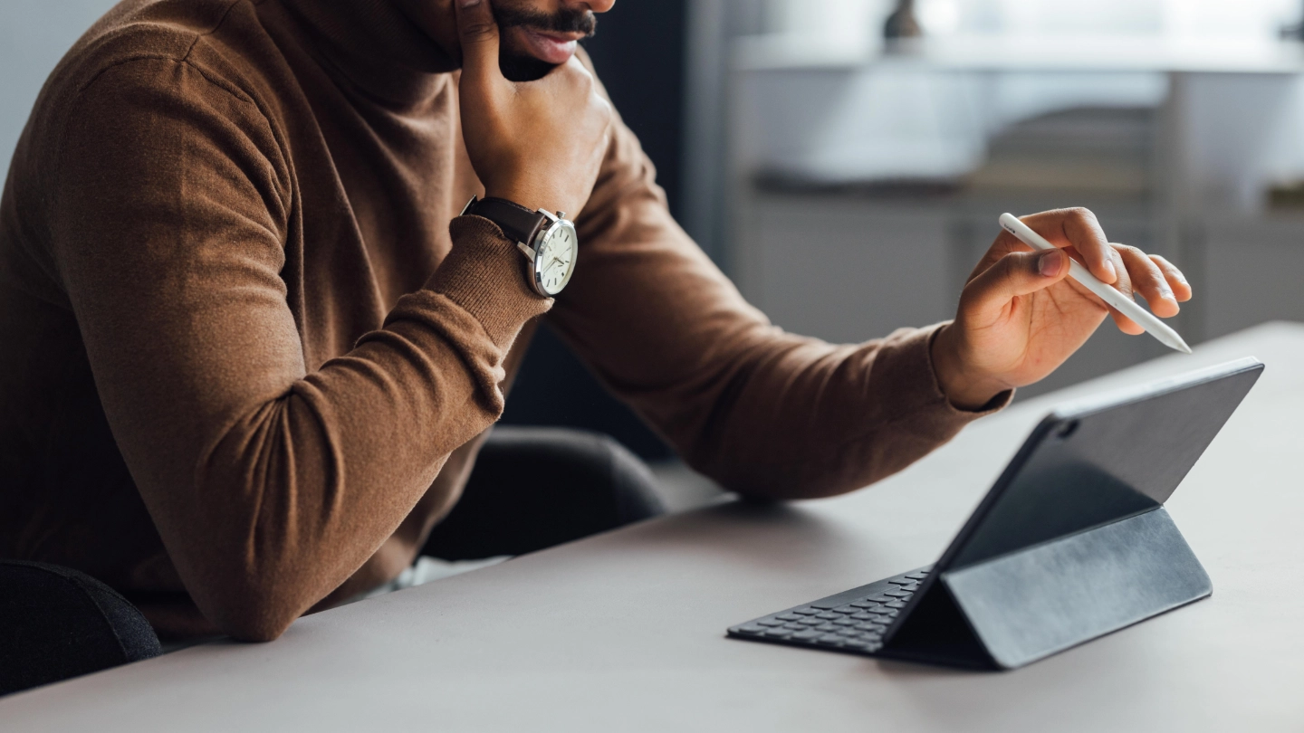Young Businessman Using Tablet in Office young businessman using a tablet